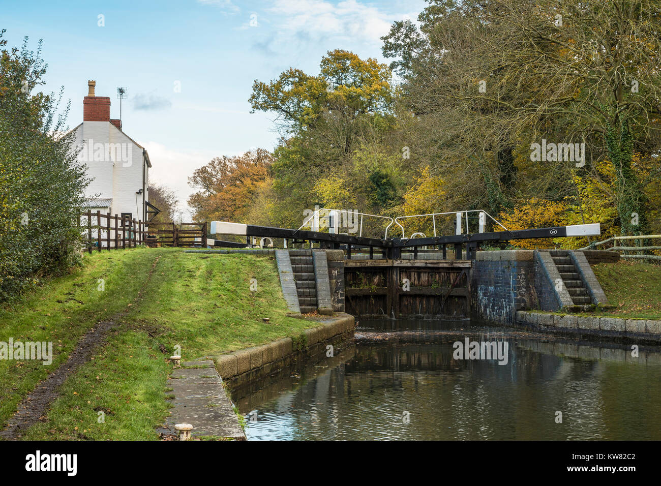 An image of a canal lock gate and lock keepers cottage situated on the ...