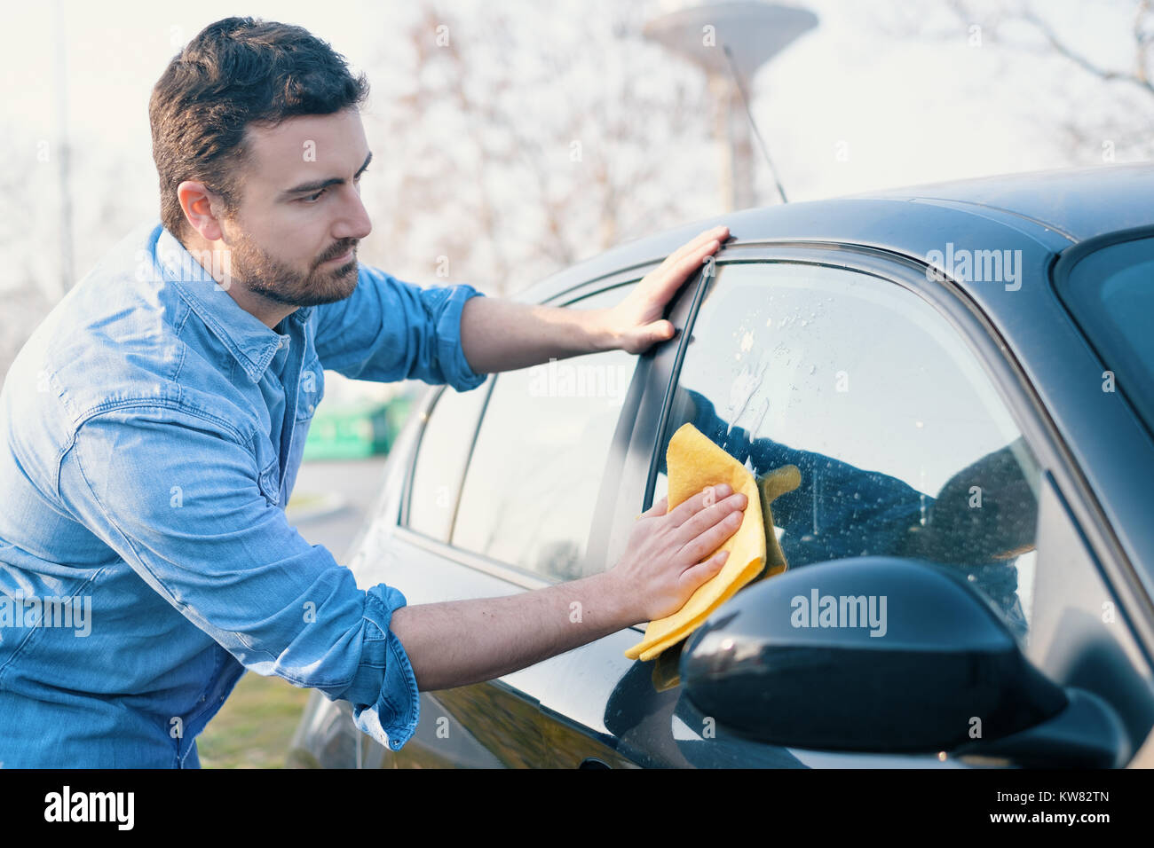 Man taking care and cleaning his new car Stock Photo