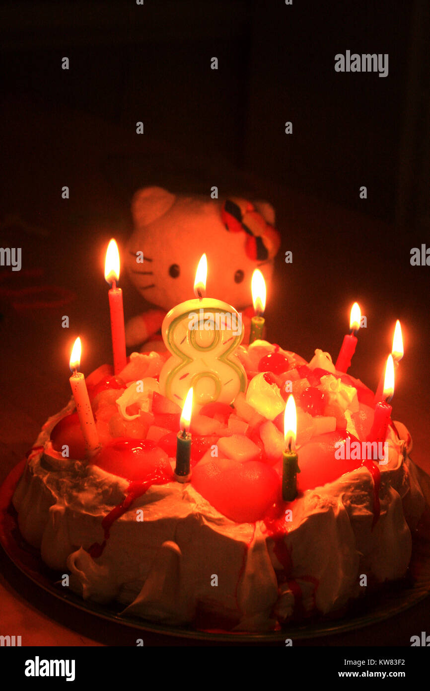 Candles burning on birthday cake Stock Photo Alamy