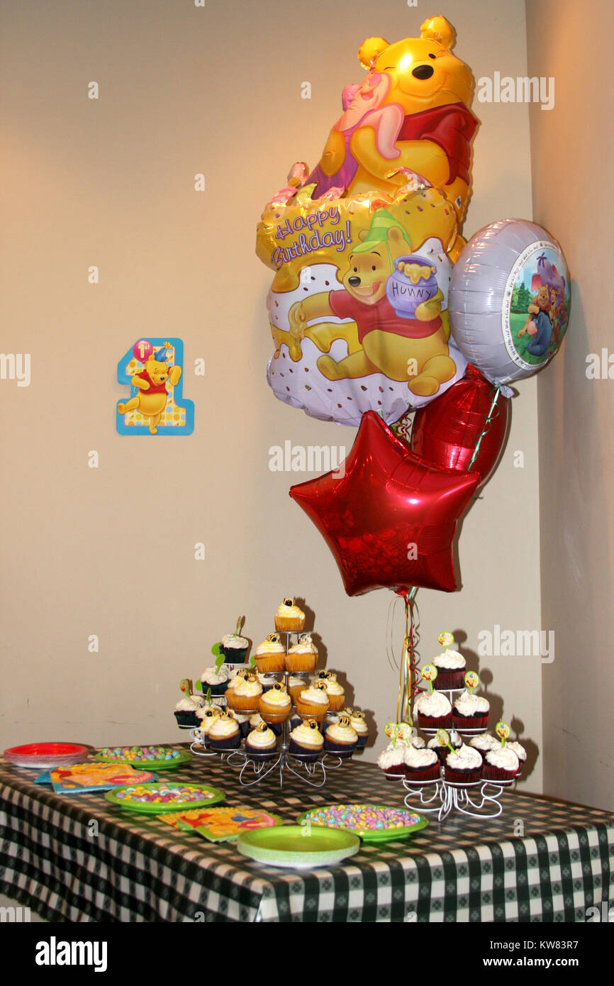Table, cupcakes and balloons set for birthday party Stock Photo