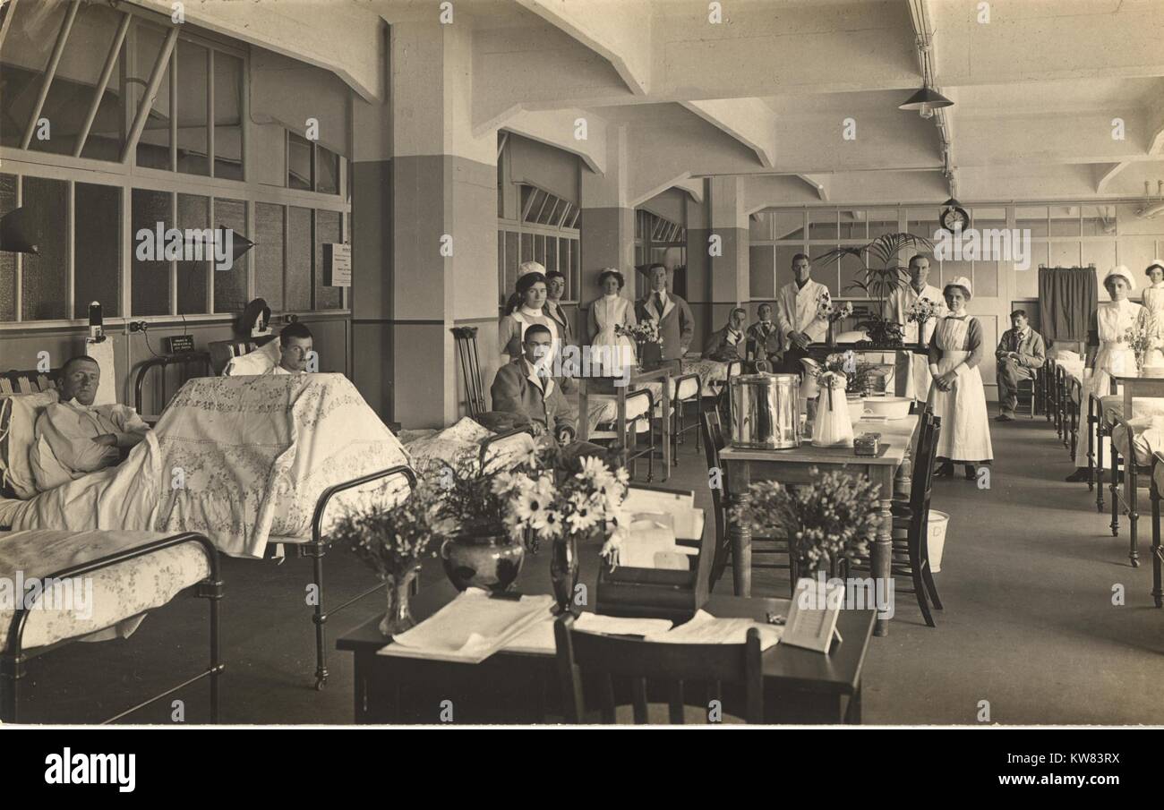Nurses treating patients in beds on either side of the room in the C2 Ward of the King George Military Hospital, London, England, 1915. Stock Photo