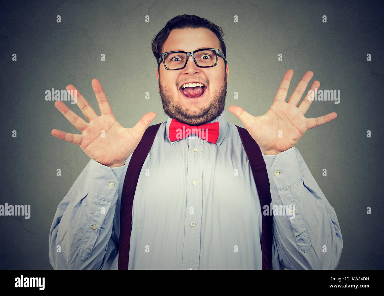 Young obese man looking super excited while posing at camera having great news. Stock Photo
