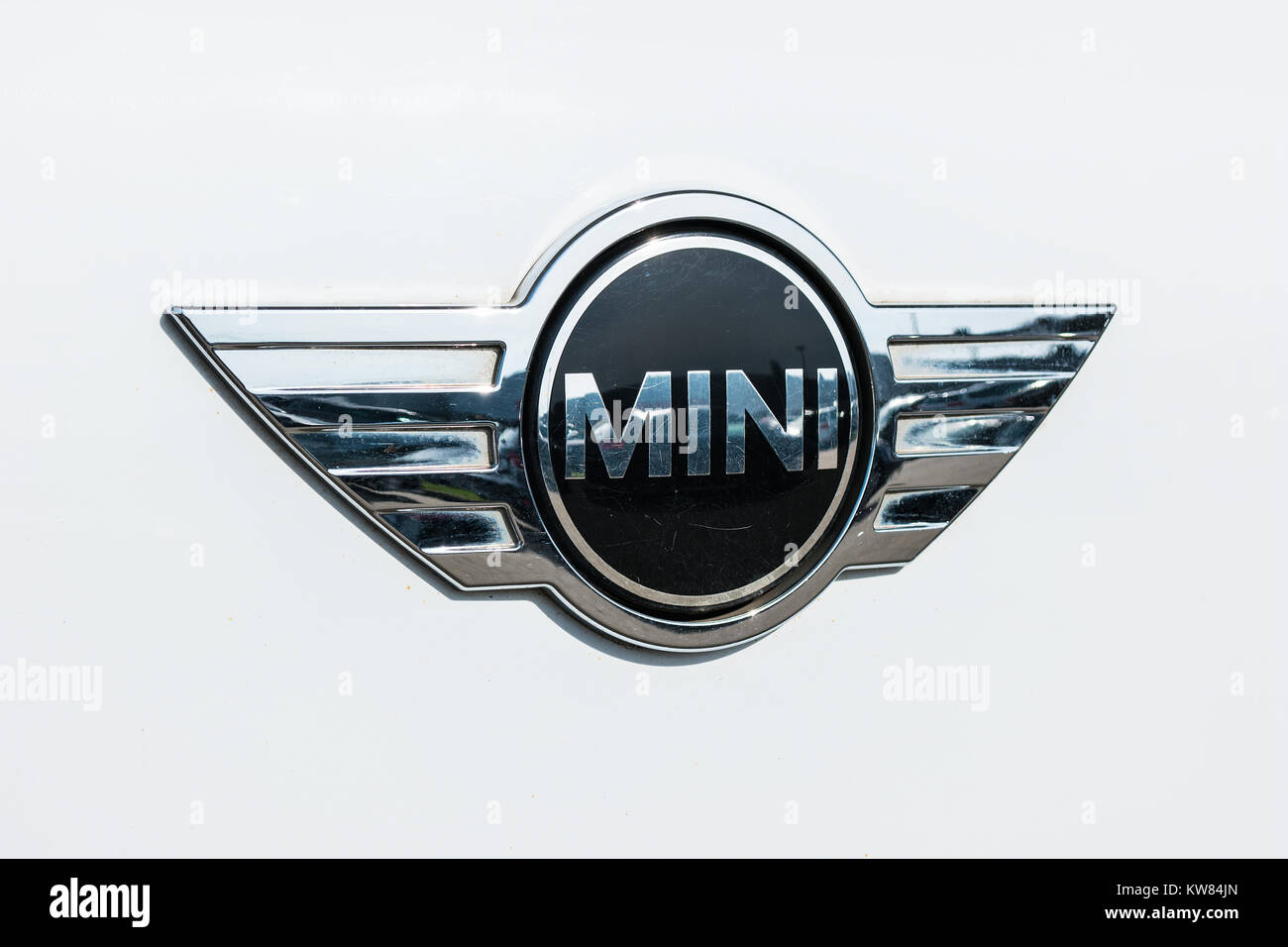 Mini cooper car logo on white car. It is a model produced by BMW since 2000. BMW is a German luxury vehicle, motorcycle, and engine manufacturing Stock Photo
