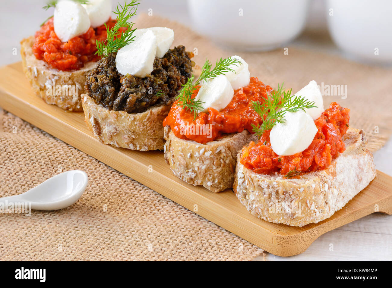 Appetizer bruschetta with mozzarella cheese, peppertomato paste, dried