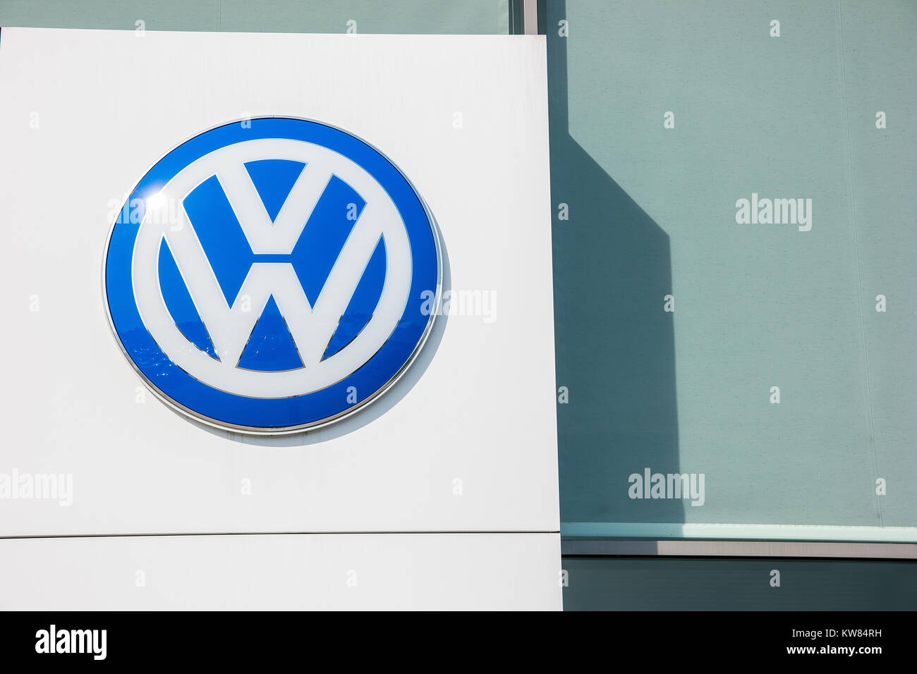 Volkswagen VW logo on a store facade. Volkswagen is a famous European car manufacturer company based on Germany. Stock Photo
