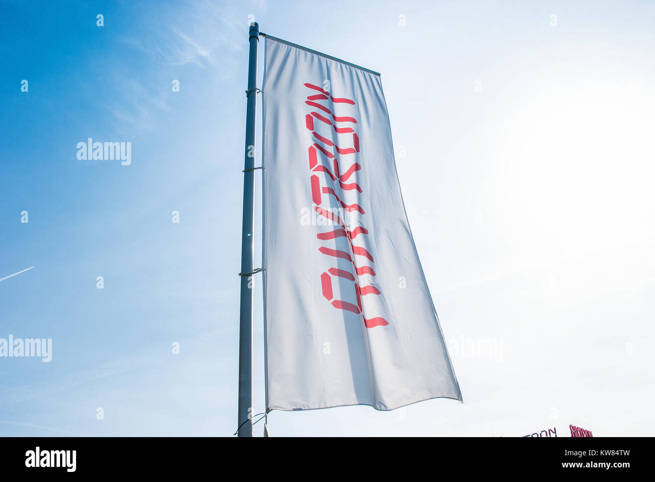 Aixtron flag against blue sky. The engineering company.produces equipment for the production of compound semiconductors and other multicomponent mater Stock Photo
