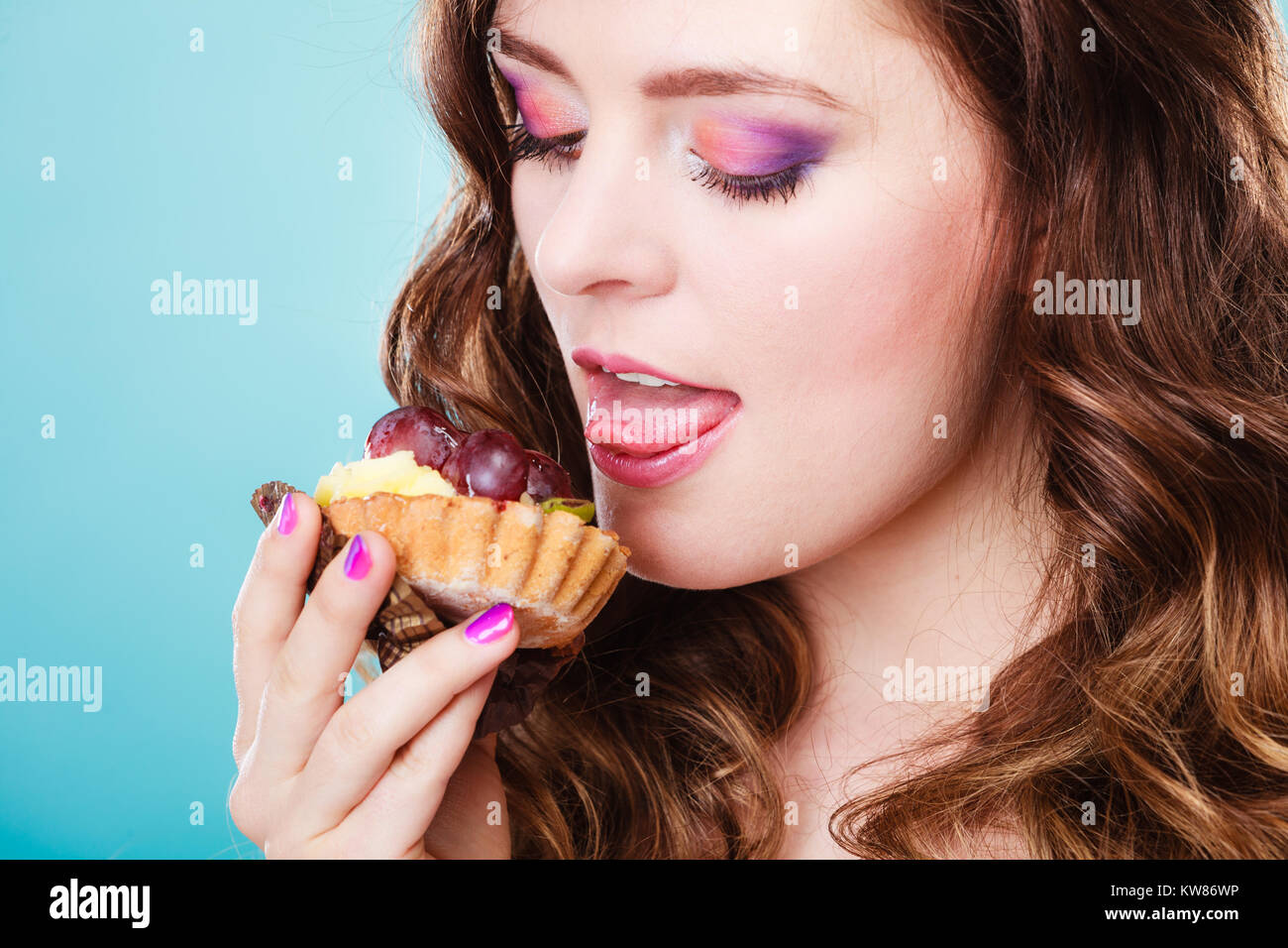 Sweet food sugar make us happy. Cute young woman colorful makeup nails