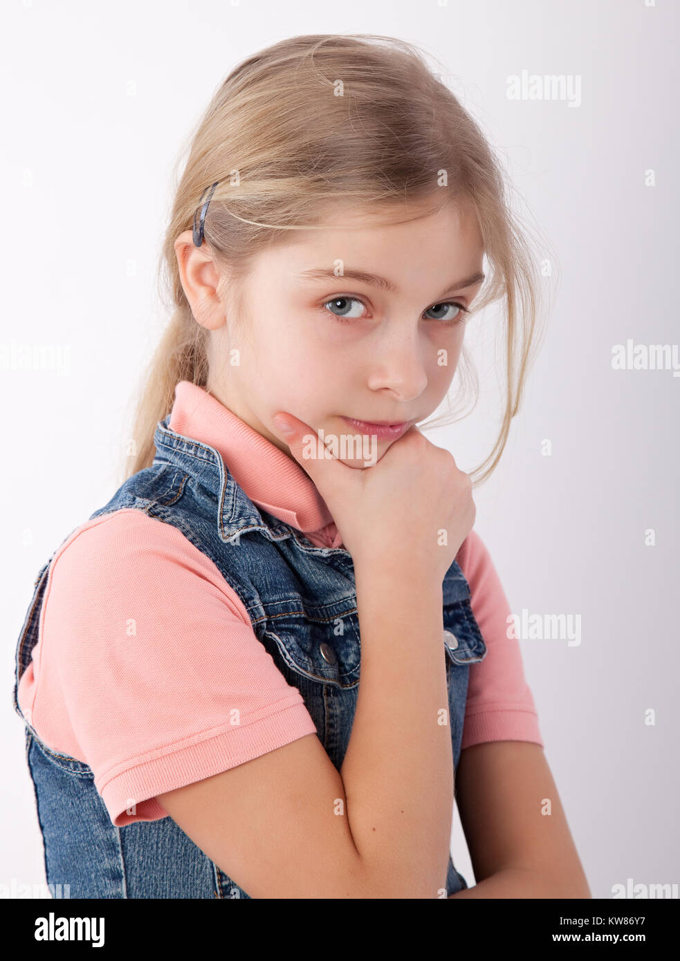 young girl with hand on chin Stock Photo