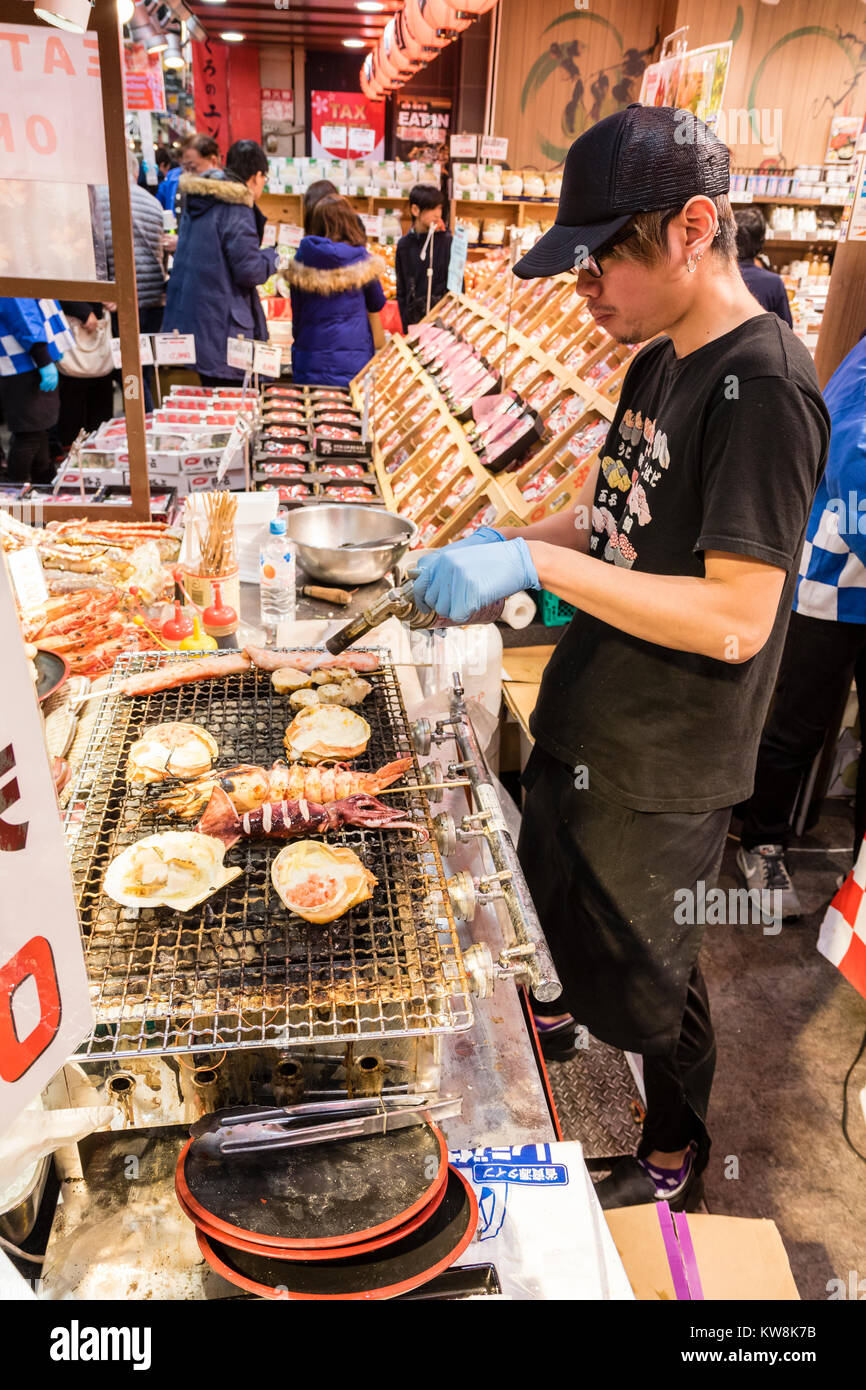 Japan, Osaka, Kuromon Ichiba Market, Osaka, Fish food stall, view along