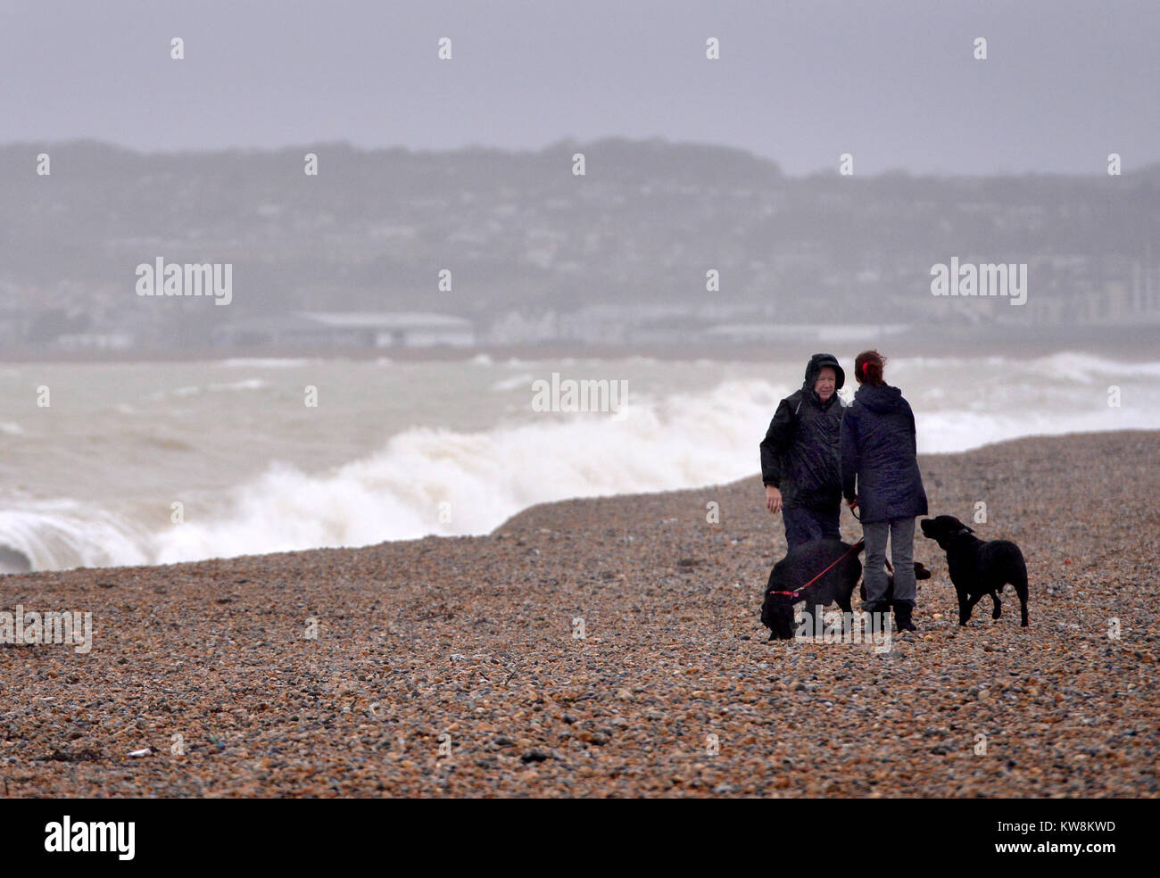 Seaford, East Sussex. 31st December 2017. Joggers and dog walkers brave the weather on Seaford seafront, East Sussex, as Storm Dylan brings strong winds and rain to the UK. Credit: Peter Cripps/Alamy Live News Stock Photo
