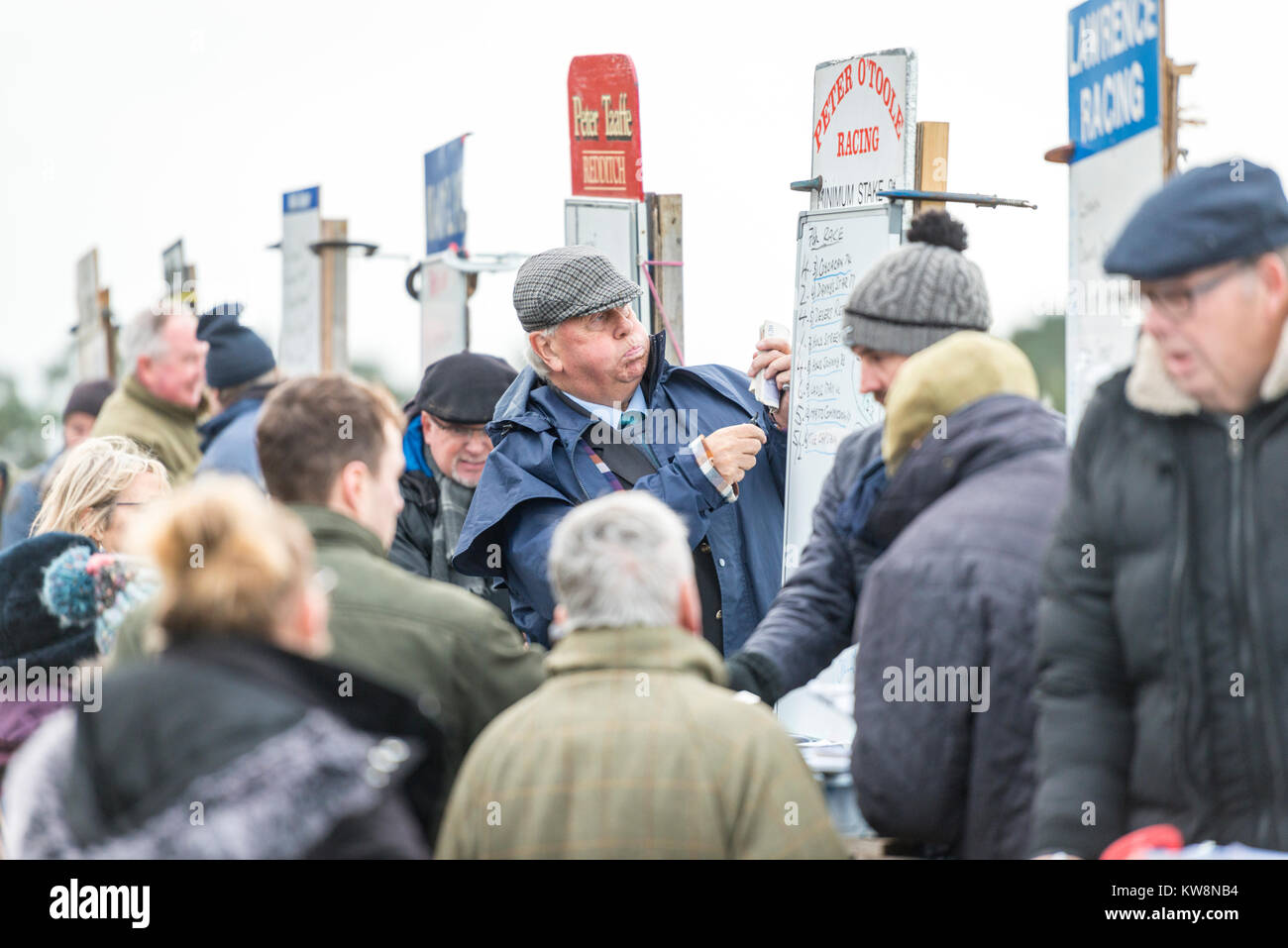 Cambridgeshire, UK. 31st December, 2017. Cottenham, Cambridgeshire UK 31st December 2017.   A bookie writes the odds at the Cambridgeshire Harriers Hunt Club Point-to-Point Races.  The small, rural racecourse holds the traditional New Year’s Eve meeting each year where riders compete in horse racing over hurdles on hunting horses. Credit: Julian Eales/Alamy Live News Stock Photo