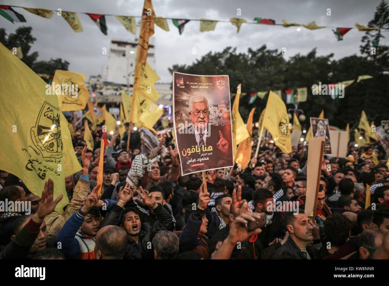 Supporters of the Palestinian national movement Fatah hold a poster of Palestinian President Mahmoud Abbas (Abu Mazen) during a rally to mark the 53rd anniversary of the political party's foundation in Gaza City, Gaza Strip, the Palestinian Territories, 31 December 2017. Photo: Wissam Nassar/dpa Stock Photo