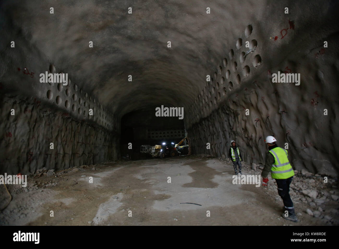 Jerusalem. 31st Dec, 2017. Israeli workers are seen at the construction site of underground burial tunnels below Jerusalem's Givhat Shaul Jewish cemetery, on Dec. 31, 2017. A shortage of burial space in Jerusalem along with the requirements of Jewish law have brought together religious undertakers and a tunnelling expert to create the new underground complex. Credit: Gil Cohen Magen/Xinhua/Alamy Live News Stock Photo