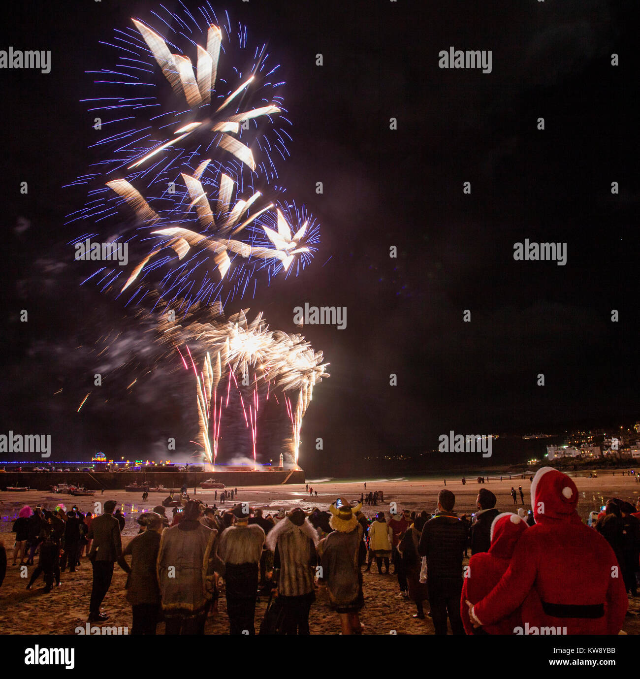 St Ives, Cornwall, UK, New Year's Eve, 2017. Party goers flood the streets of the Cornish fishing village in fancy dress for the New Year's Eve celebrations. Credit: Mike Newman/Alamy Live News Stock Photo