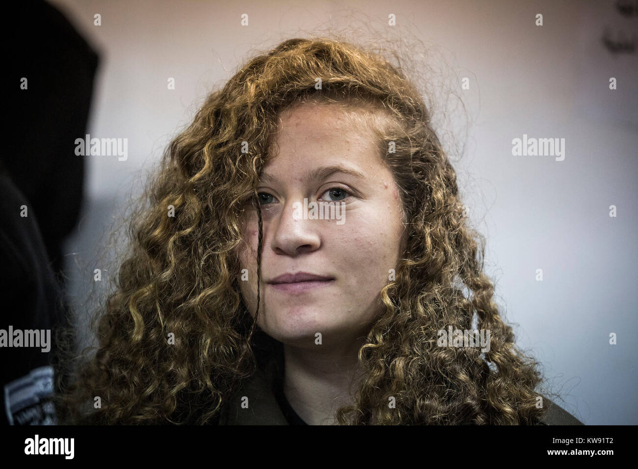 16-Year-old Palestinian Ahed Tamimi attends a hearing at the military court of the Israeli-run Ofer military prison in the West Bank city of Beitunia, the Palestinian Territories, 01 January 2018. The Israeli army arrested Tamimi in a controversial night raid on 18 December 2017, after she was filmed repeatedly slapping and hitting Israeli soldiers. Tamimi was indicted, by the Israeli Army's military prosecutor, on five counts of assaulting Israeli soldiers. Photo: Ilia Yefimovich/dpa Stock Photo