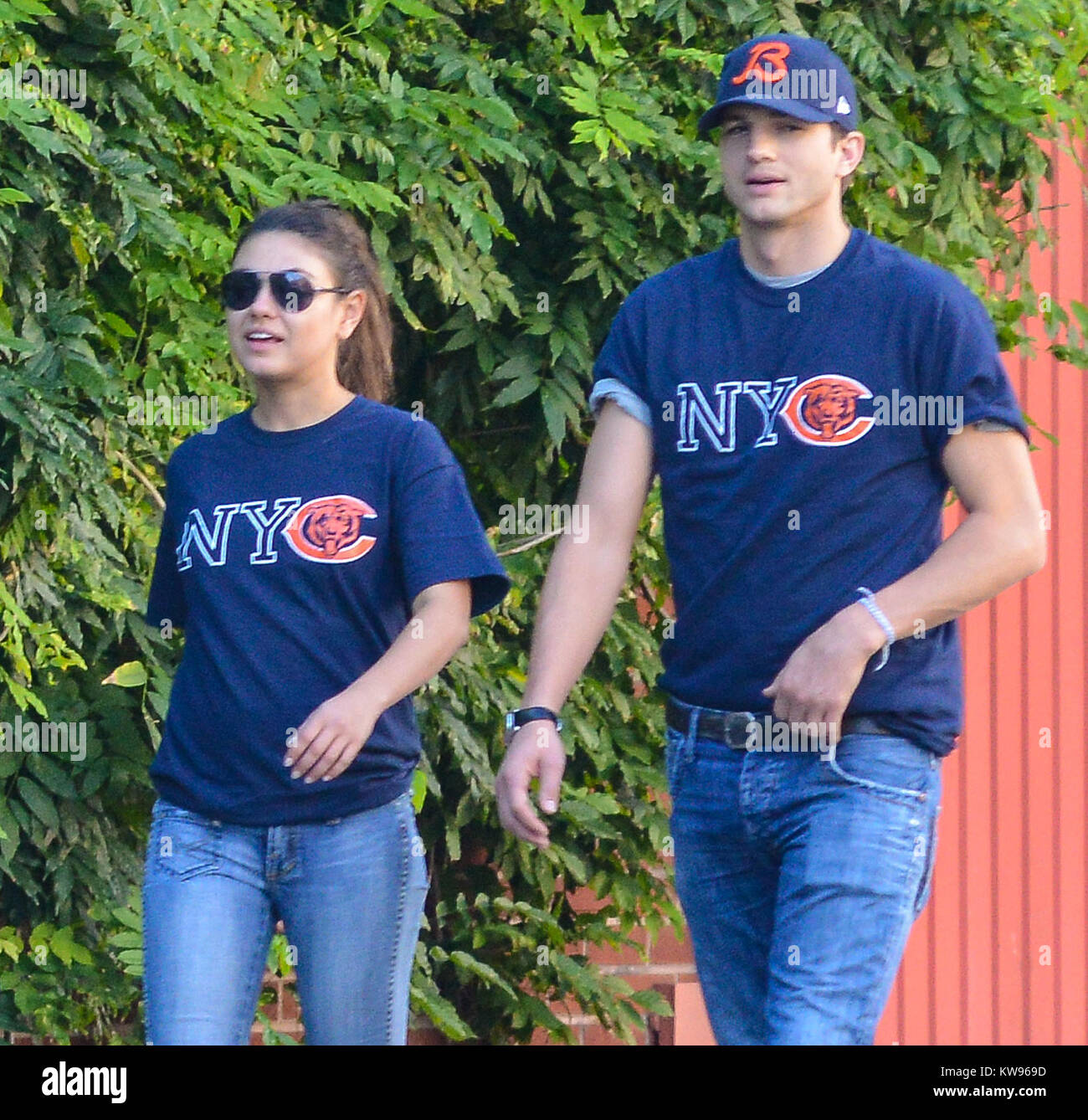 NEW YORK, NY - SEPTEMBER 23: Mila Kunis and Ashton Kutcher wear matching Chicago Bears NYC shirts on September 23, 2012 in New York City  People:  Mila Kunis Ashton Kutcher Stock Photo