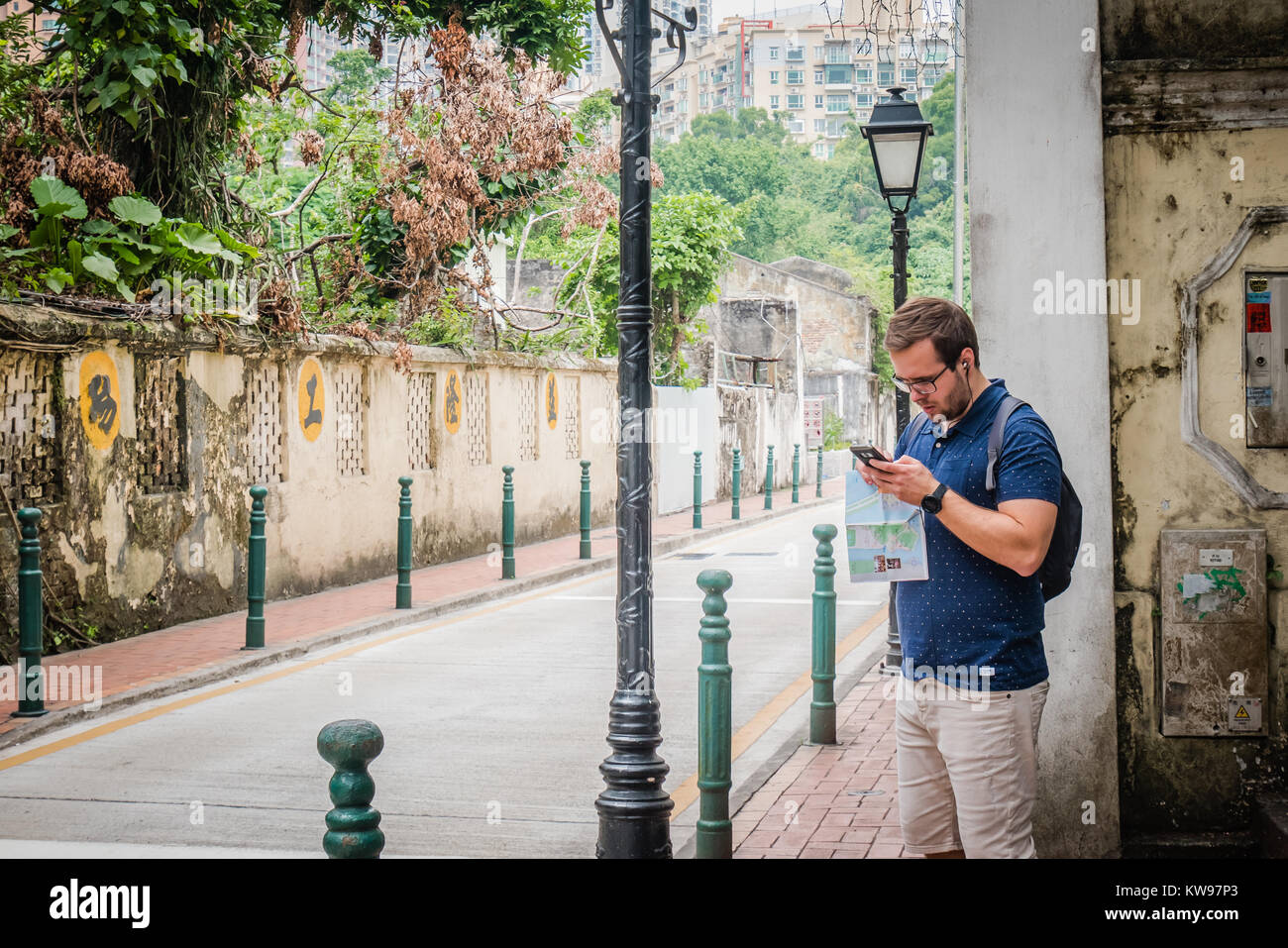 tourist checking phone for direction Stock Photo