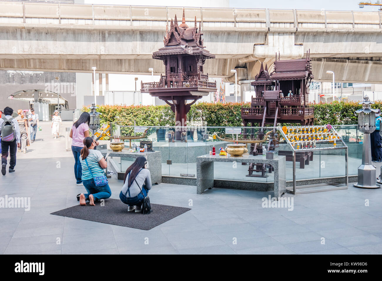 thai people kneeling down praying in the public Stock Photo