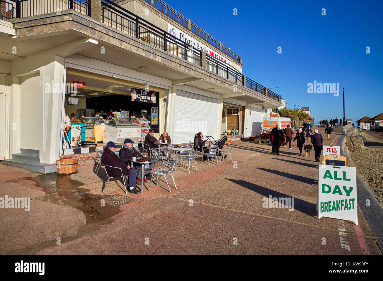 People enjoying the winter sunshine on the seafront at Clacton on Sea, Essex Stock Photo