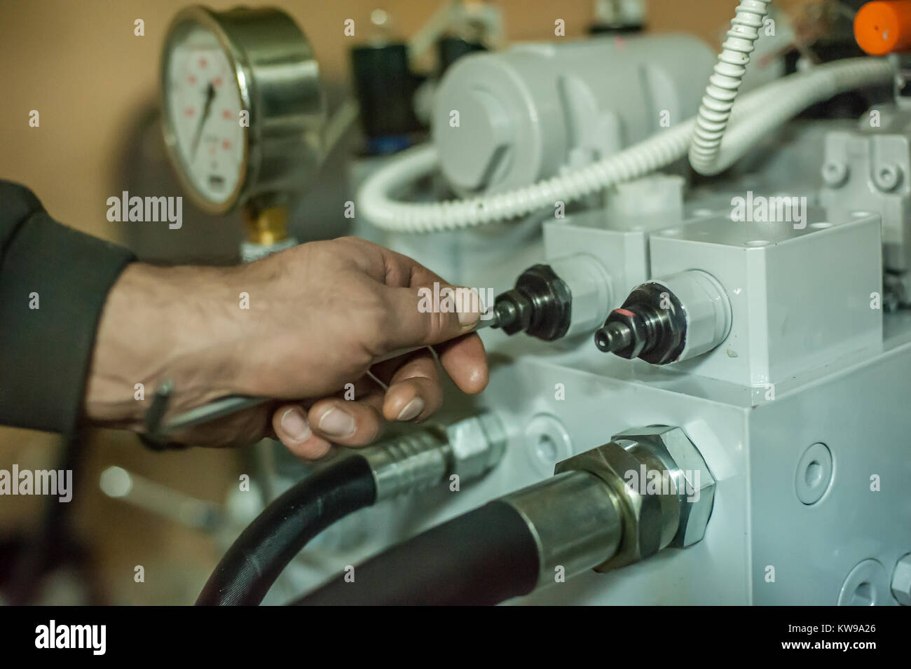 Industrial machinery mechanics and factory worker adjusts industry