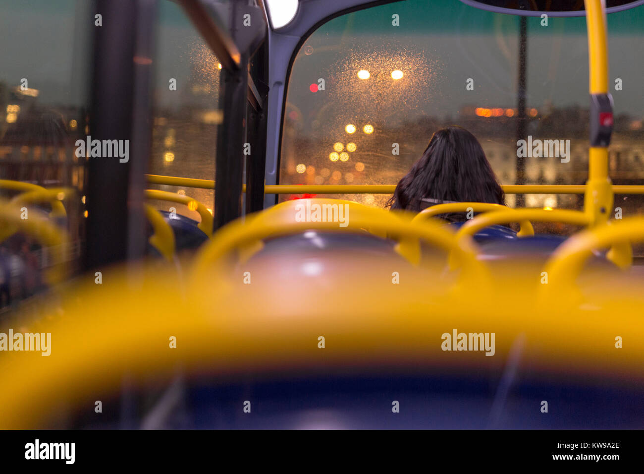 Woman travelling on upper deck of London bus, crossing the Thames. Stock Photo