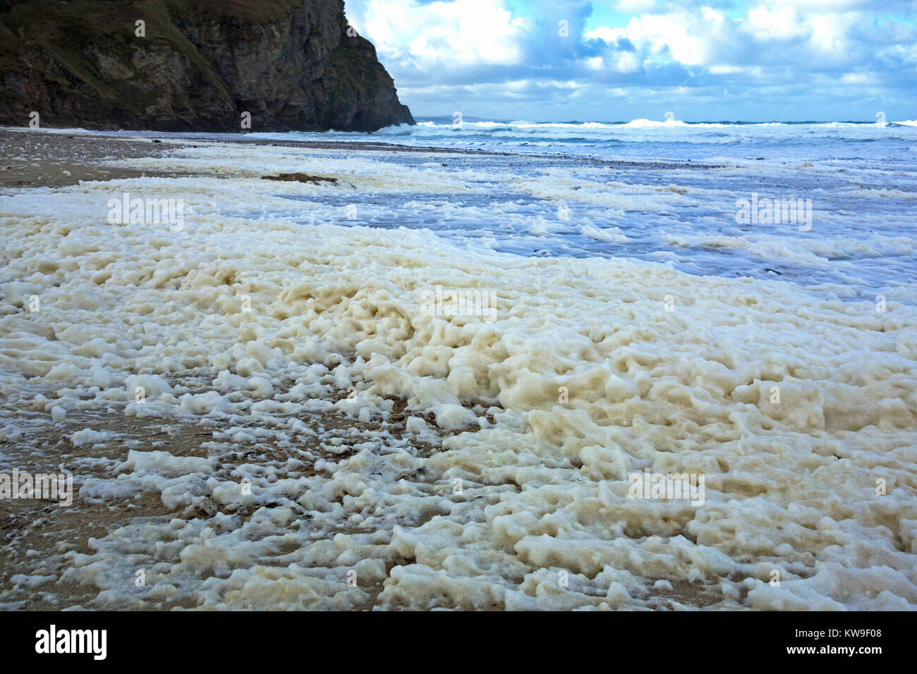 sea foam, ocean foam, beach foam or spume on porthtowan beach cornwall, uk, the foam is usually created during stormy weather. Stock Photo