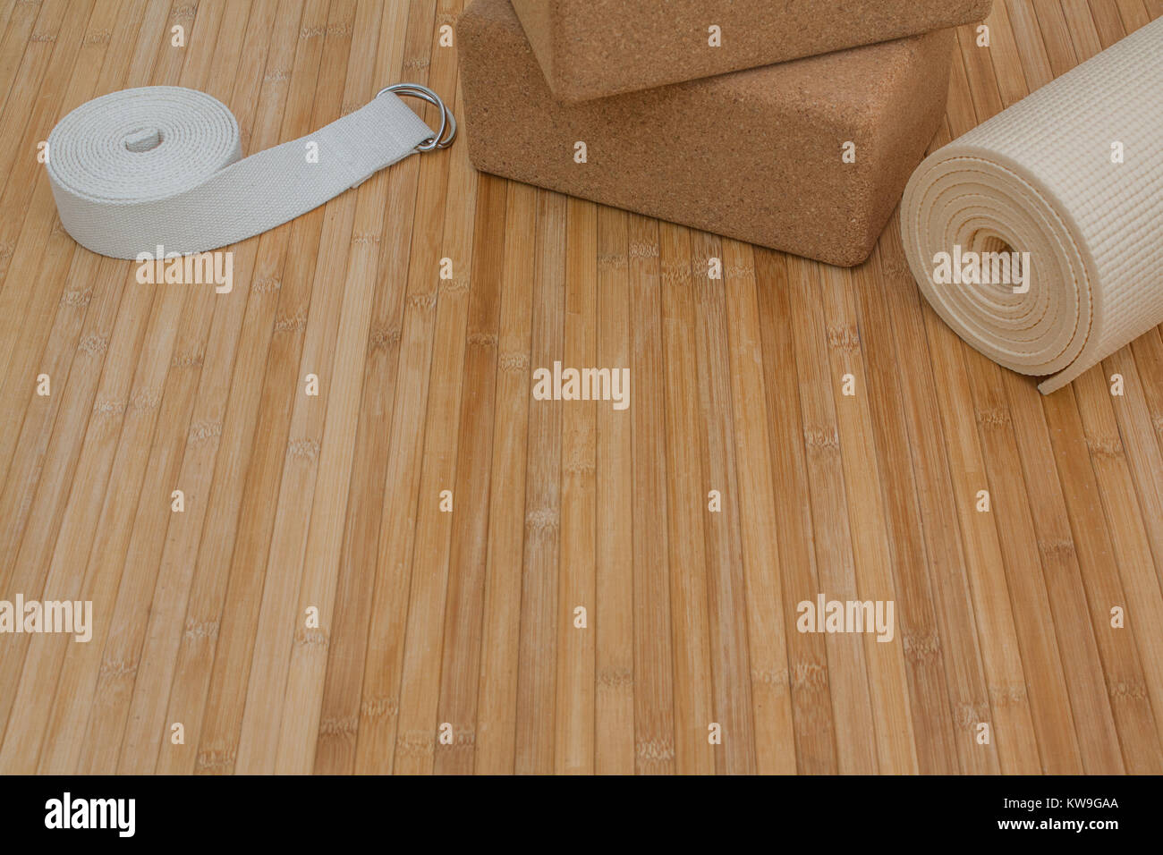 Yoga class supplies on bamboo mat floor ready for yoga retreat Stock