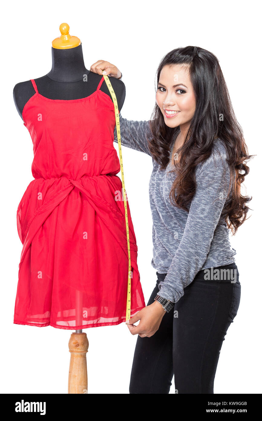 A portrait of a young asian designer woman measuring and smiling, look ...