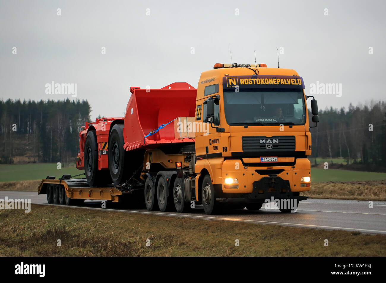TENHOLA, FINLAND - DECEMBER 28, 2017: MAN TGA 41.530 truck of Nostokonepalvelu transports Sandvik LH517 Underground loader along highway. The mining v Stock Photo