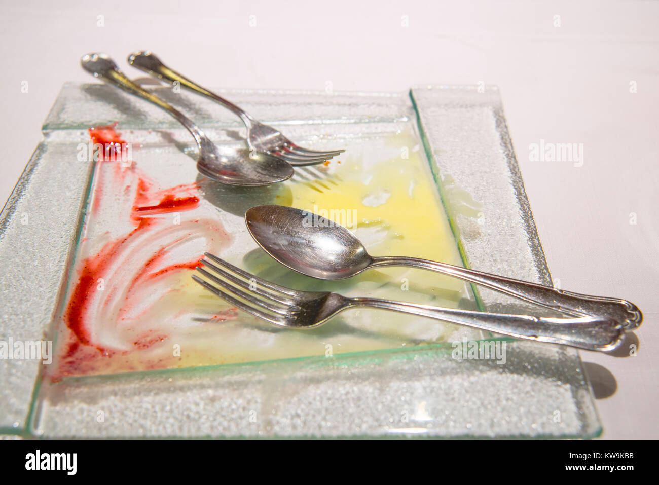 After eating dessert: empty dish with forks and spoons. Stock Photo
