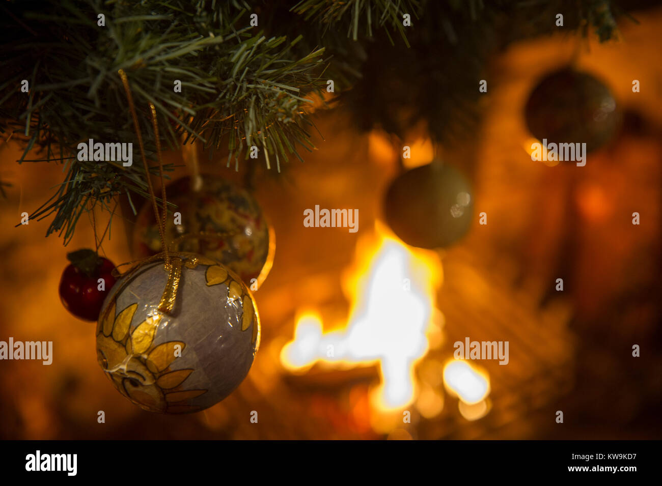 Festive winter tree decorations with large silky poinsettia flowers,  glitter tree balls and golden mesh ribbons, seasonal Christmas ornamentas  Stock Photo - Alamy