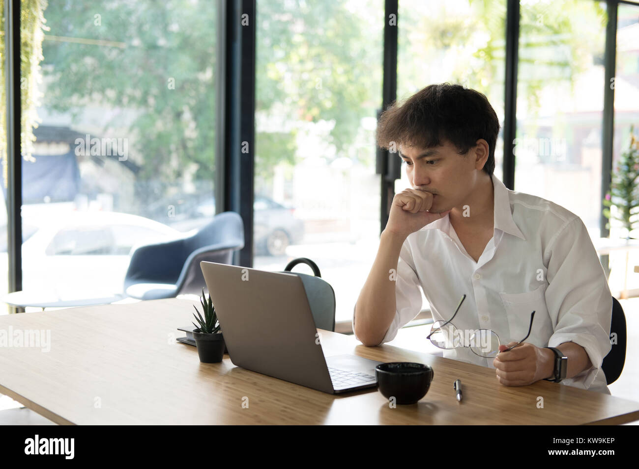 asian student using computer for learning leasson online at cafe ...