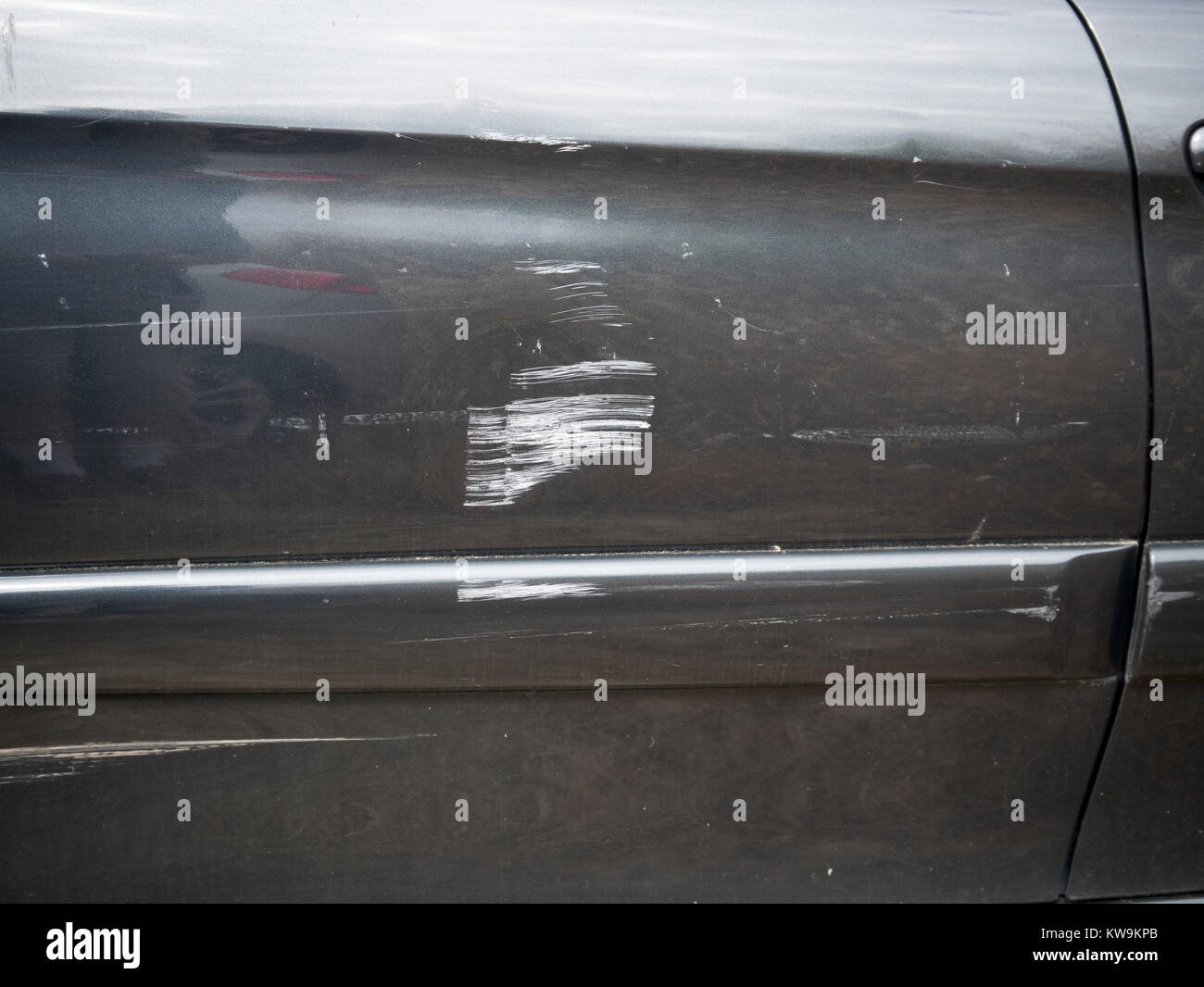 Scratches on the rear wing of a black car Stock Photo