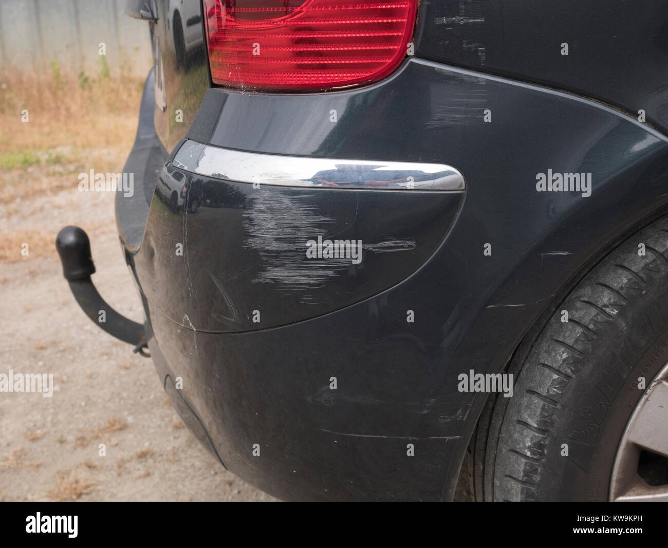 Scratches on the rear wing of a black car Stock Photo