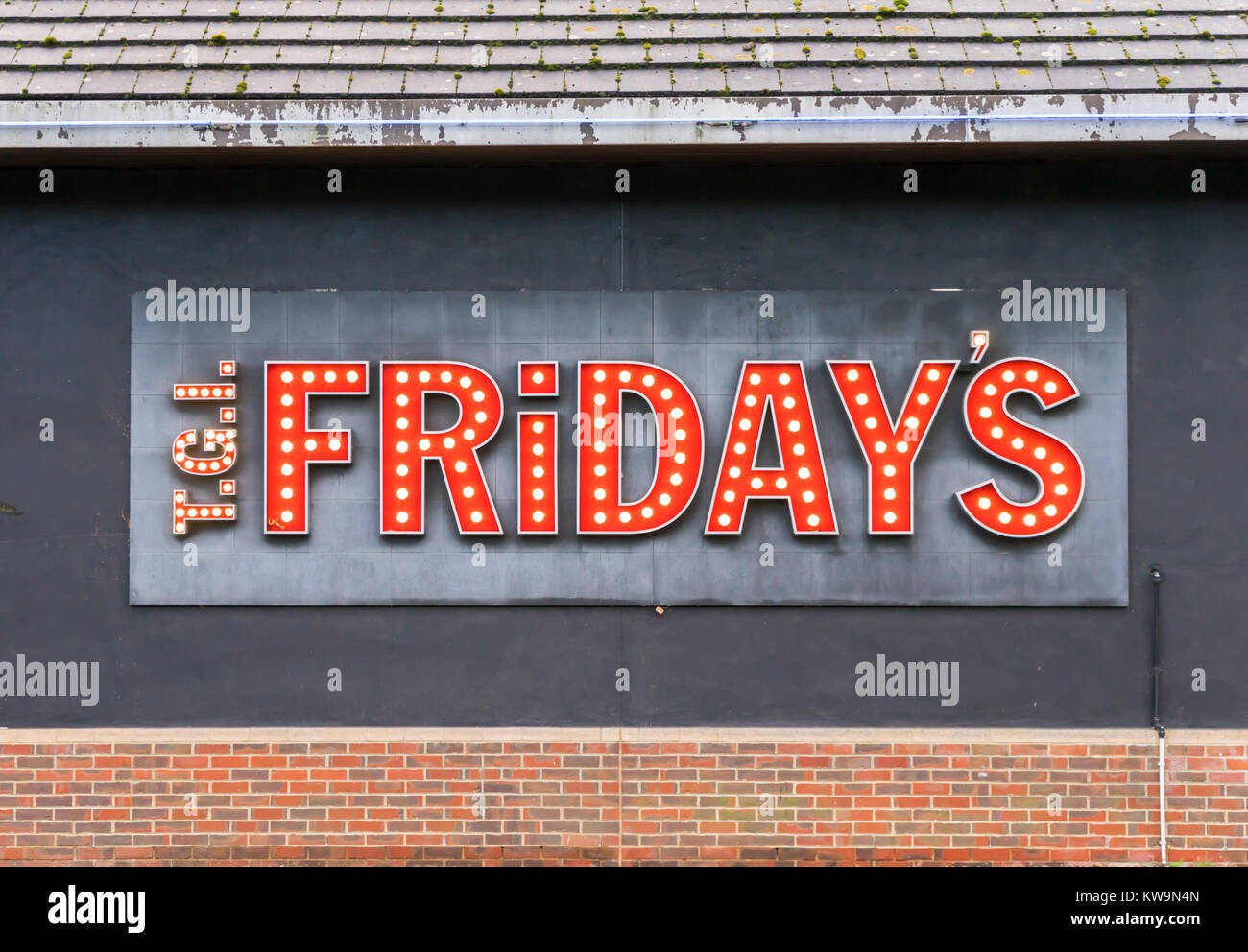 TGI Fridays restaurant chain illuminated logo/ sign in red letters outside a restaurant in the UK in 2018 Stock Photo