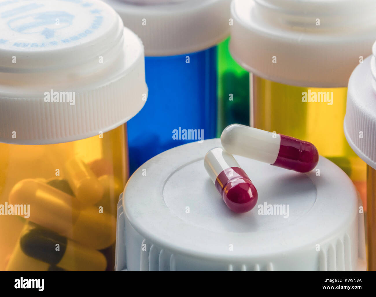 Two capsules of white and red color on a boat of medicines of plastic ...