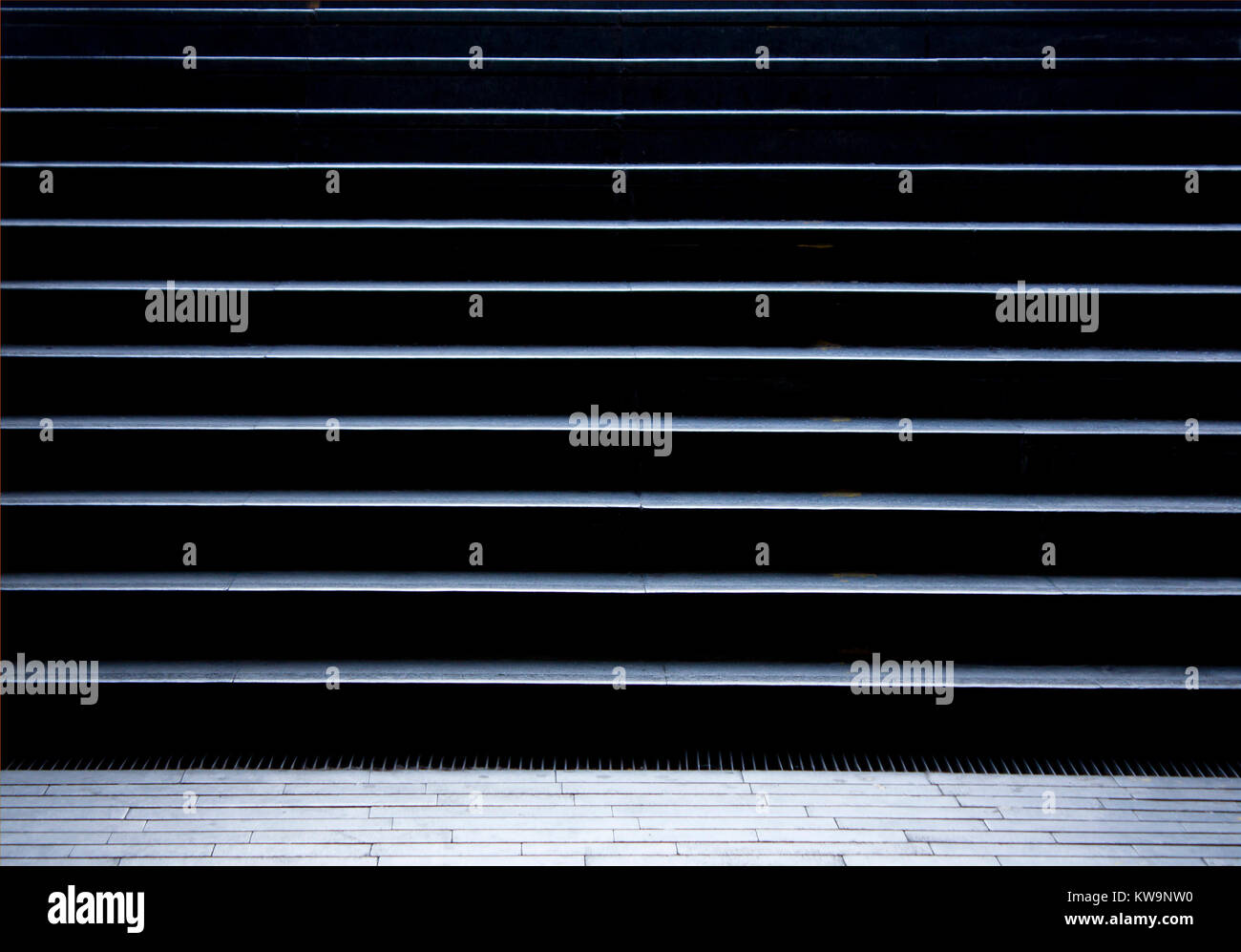 Empty pedestrian stairs in city subway passage in the night in black and white Stock Photo