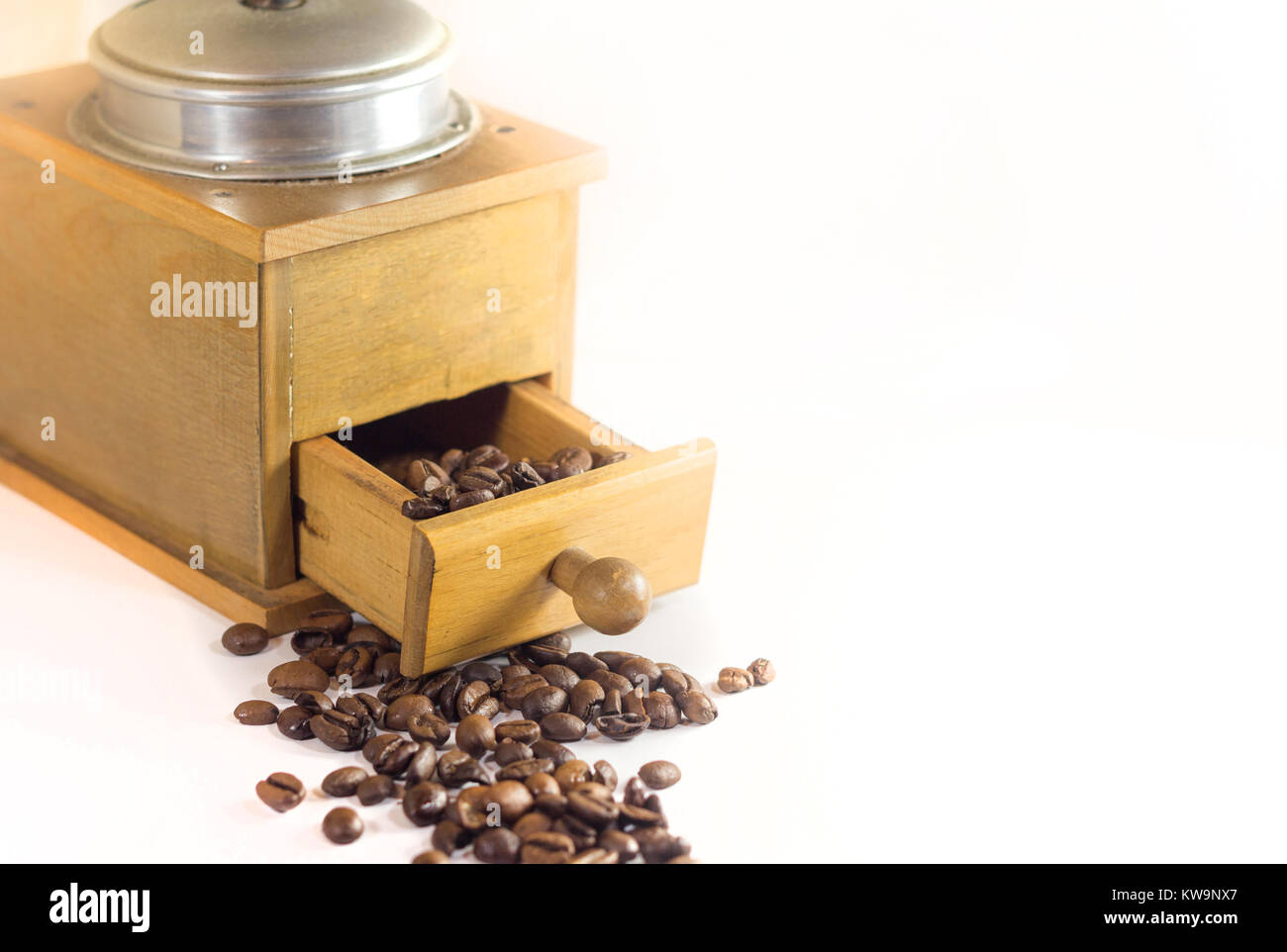 Vintage Coffee grinder and roasted coffee beans isolated on white Stock