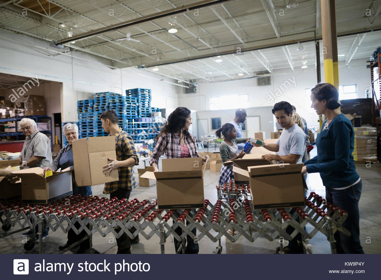 Volunteers filling donation boxes in warehouse Stock Photo Alamy