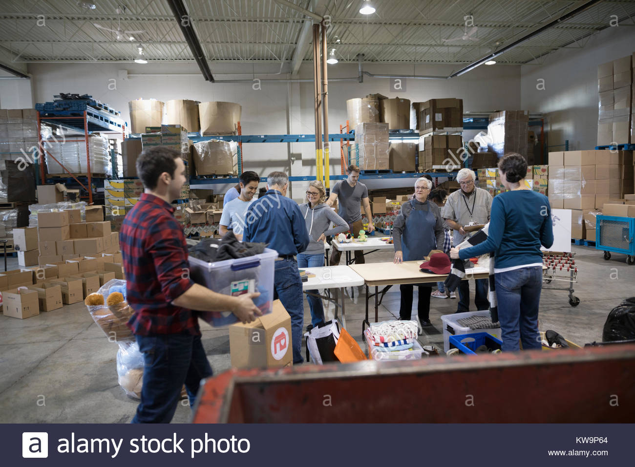 Volunteers sorting donations in warehouse Stock Photo Alamy