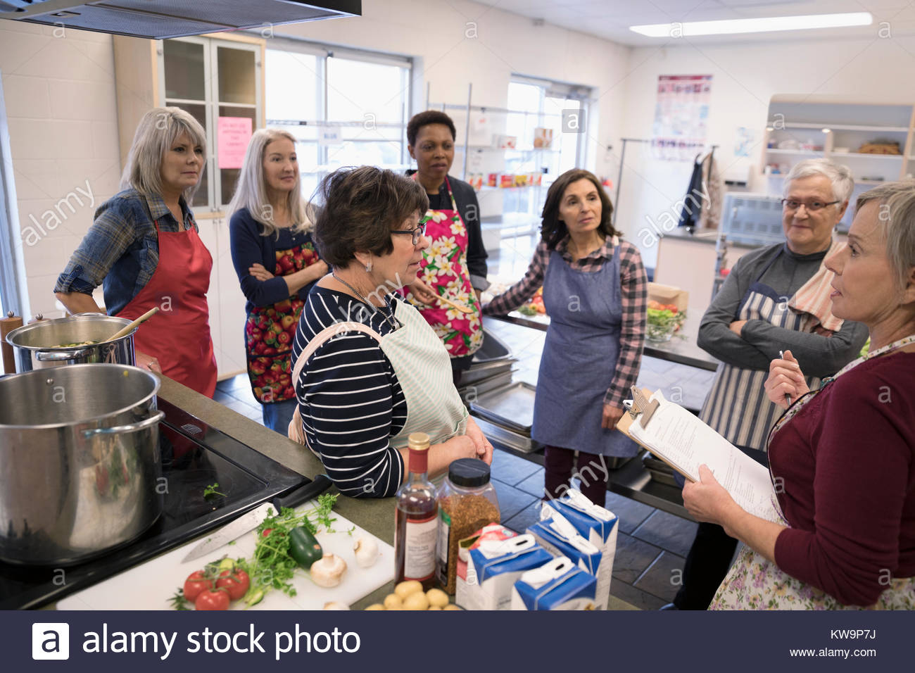 Female volunteer leading meeting in soup kitchen Stock Photo Alamy