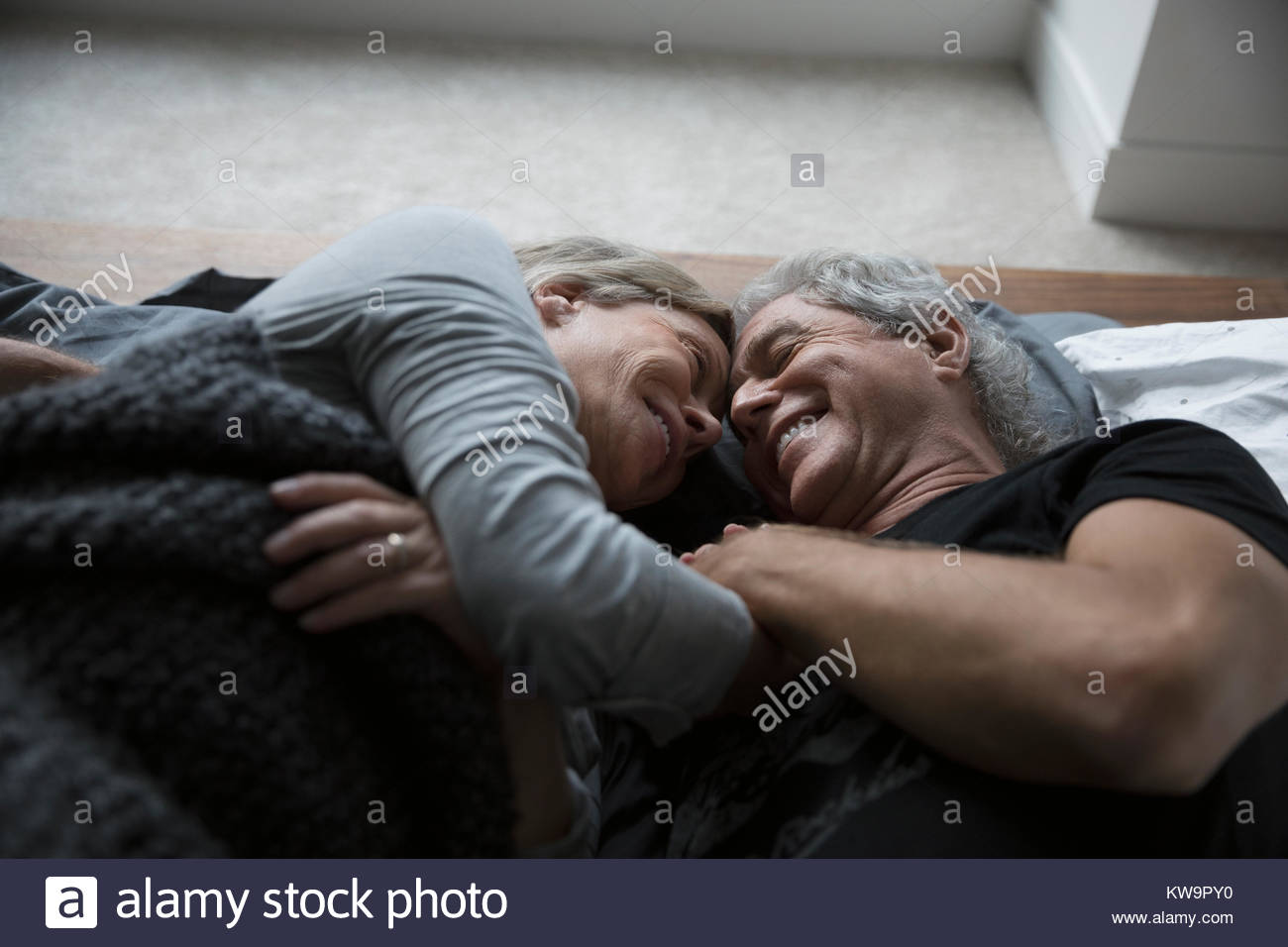 Affectionate,romantic senior couple cuddling in bed Stock Photo