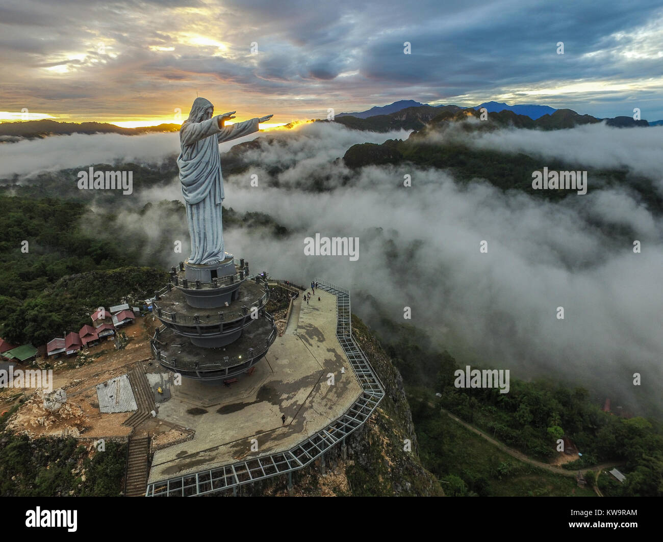 Statue of Jesus Christ at Buntu Burake Hill, Tana Toraja - South Sulawesi, Indonesia. The cloud appear every morning covering the city of Makale. Stock Photo