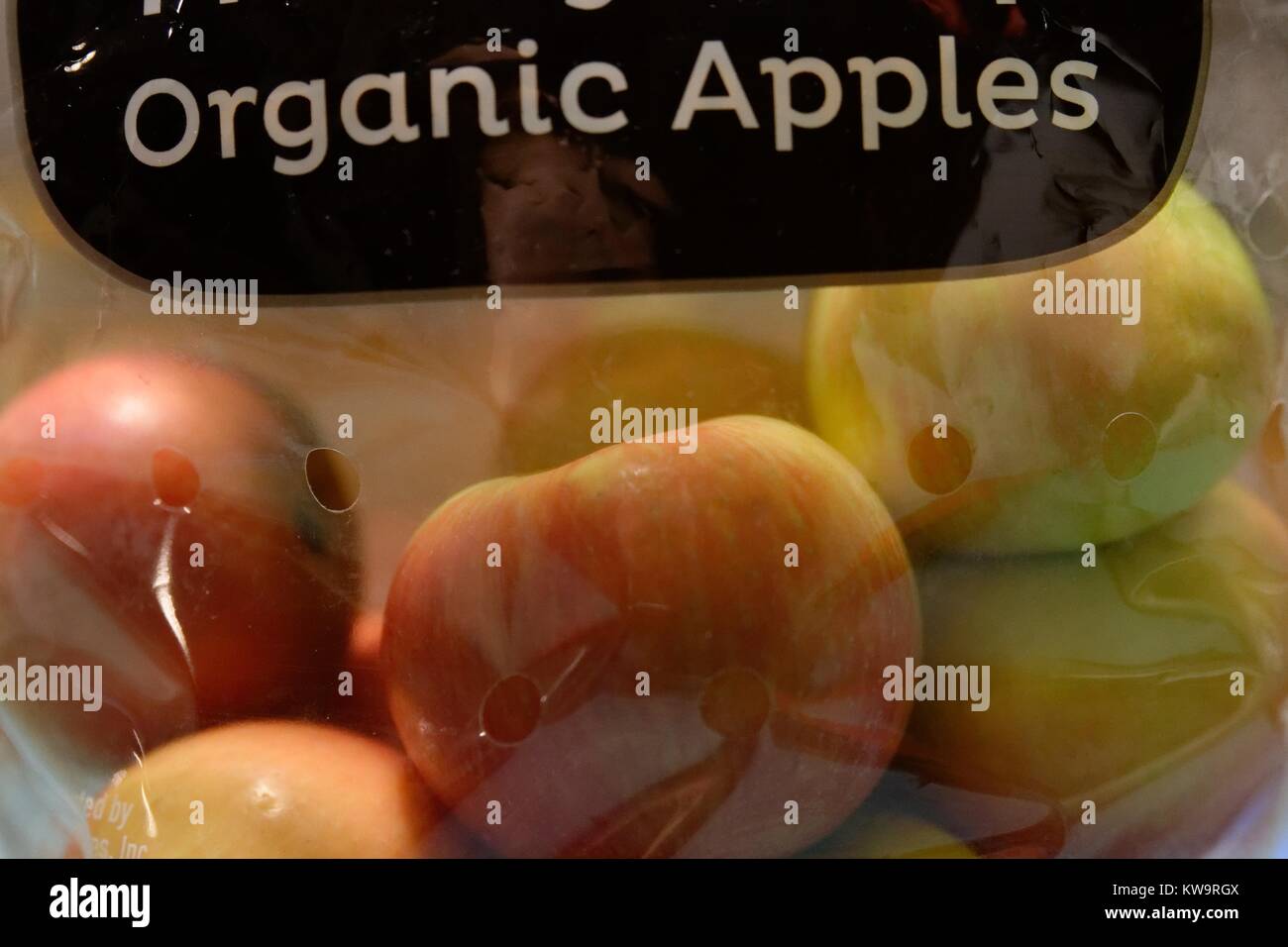 Closeup of fresh organic apples in plastic packaging.Supermarket packaging for ripened, healthy food. Stock Photo