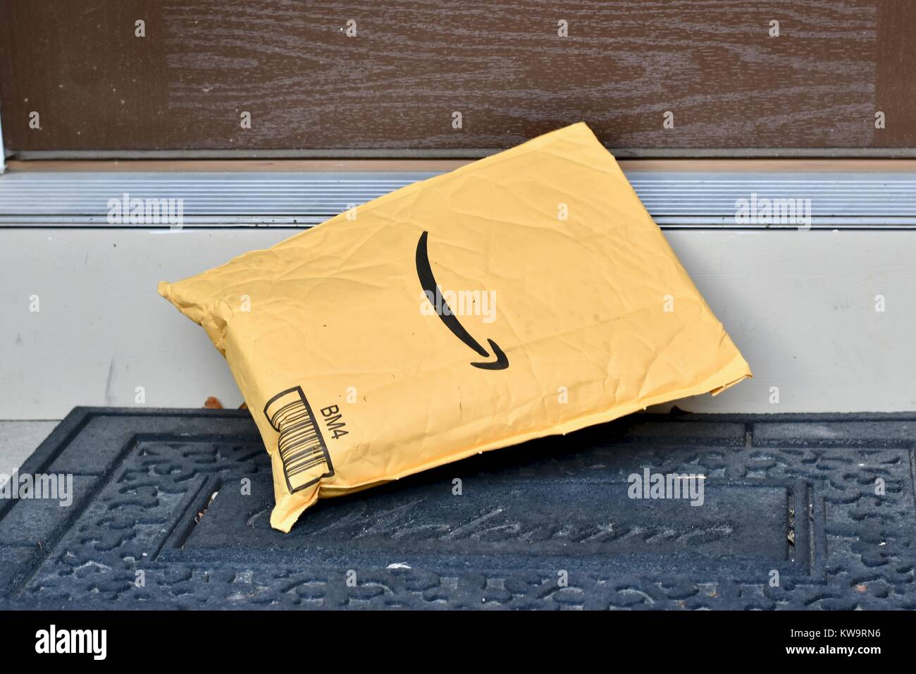 Amazon Prime package laying on the door mat at a residential home Stock Photo