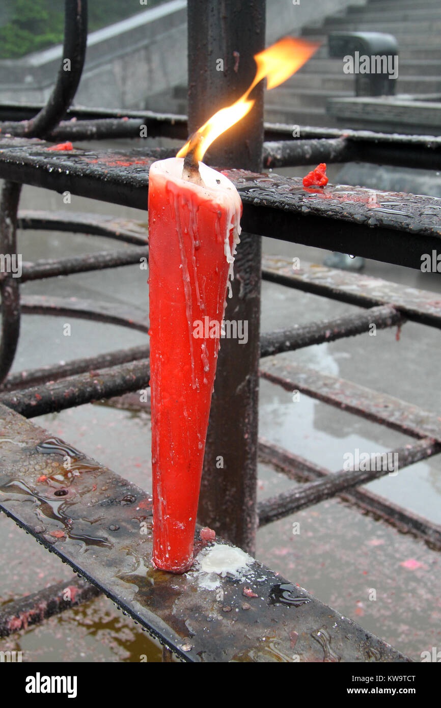 Flame a nd red candle on the buddhist shrine in the temple on the EmeiShan Stock Photo