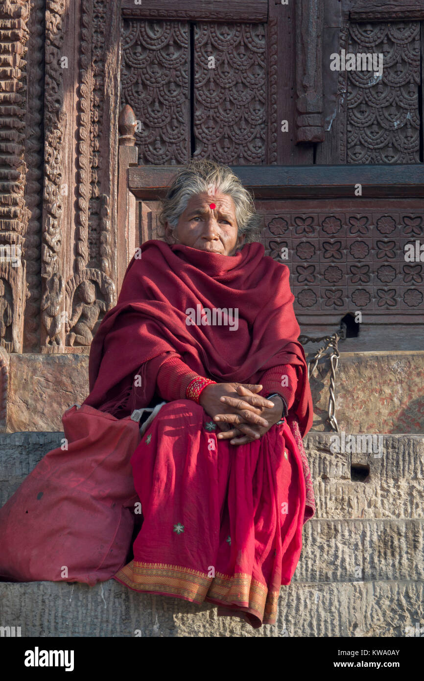 Old woman with bindi sitting in Kathmandu Durbur Square, Nepal Stock Photo