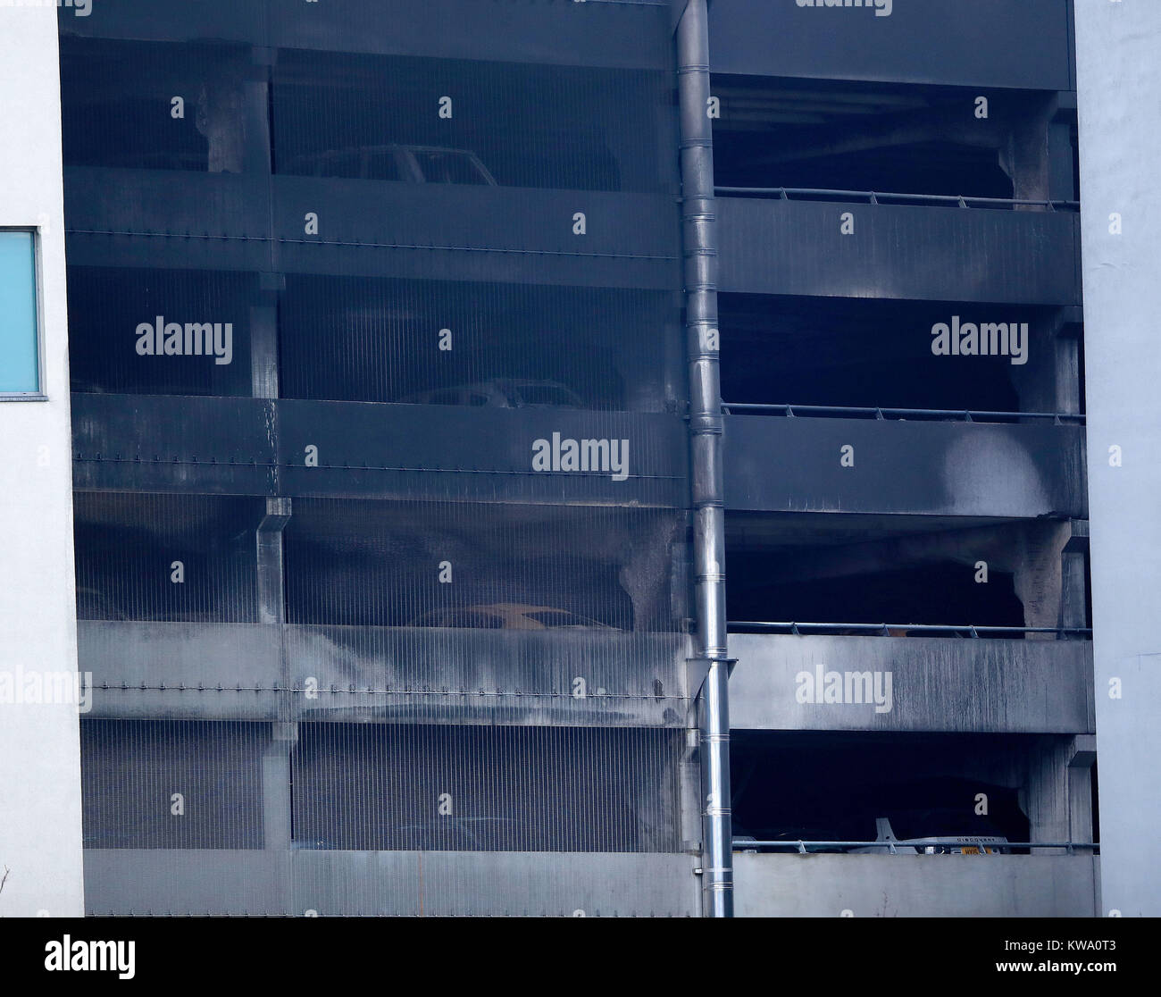 The burnt out shells of cars are seen at multi storey car park near the Echo Arena in Liverpool, after last night's fire which destroyed hundreds of cars. Stock Photo