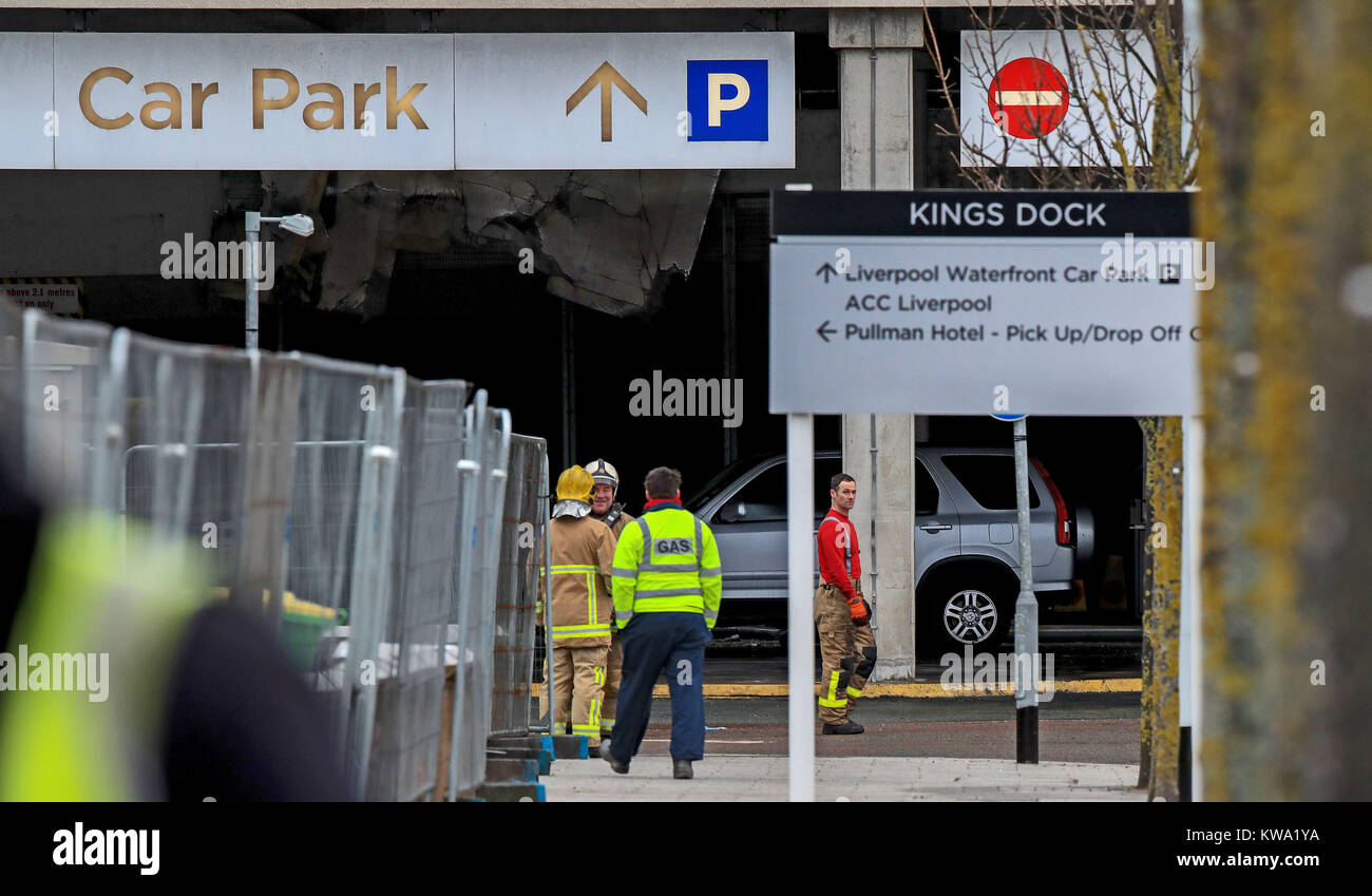 Fire crews at multi storey car park near the Echo Arena in Liverpool, after last night's fire which destroyed hundreds of cars. Stock Photo