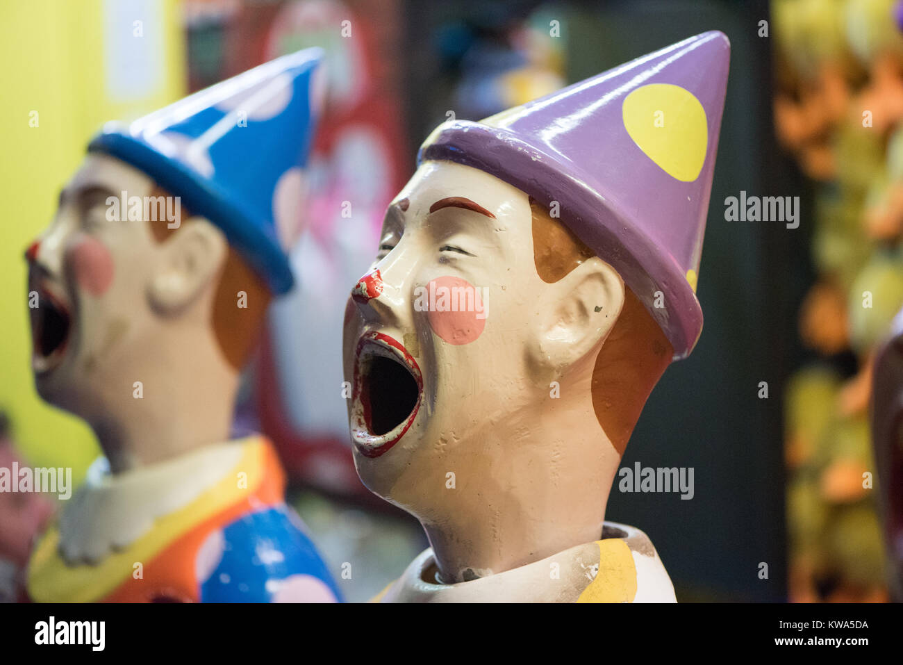 Brightly coloured laughing clowns at an amusement park Stock Photo - Alamy